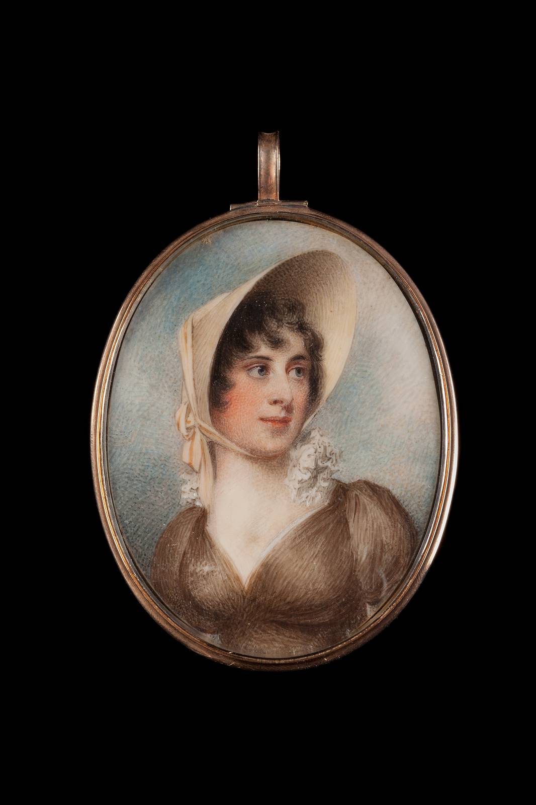 This image shows a portrait of a woman from an earlier era, set in an oval, metallic frame. The person depicted wears a large, light-colored cap and a dark brown dress with a plunging neckline and white lace collar. Her gaze appears thoughtful, and she has slight blushes on her cheeks.